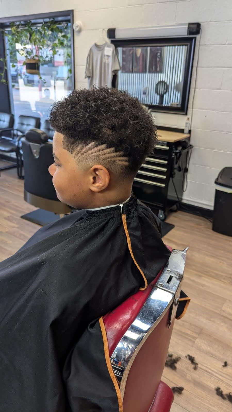 Barber giving a precise fade at NICELYDONE barbershop